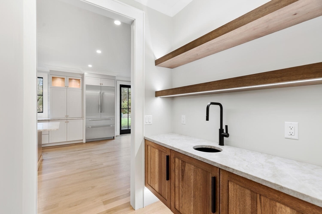 969 South Street Needham, MA 02492 - Photo 11 of 32 a kitchen with a sink and refrigerator