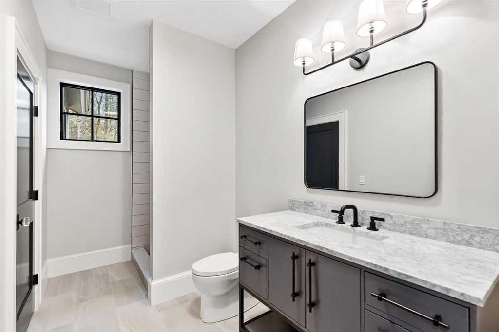 969 South Street Needham, MA 02492 - Photo 17 of 32 a bathroom with a toilet a sink and mirror