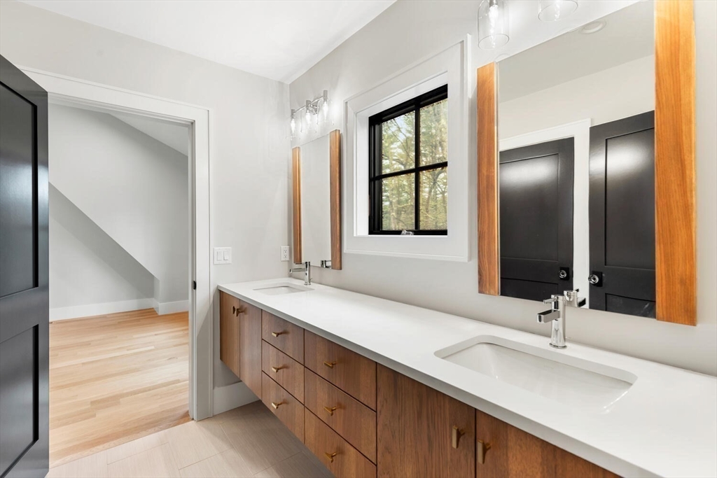 969 South Street Needham, MA 02492 - Photo 18 of 32 a bathroom with double vanity and a mirror