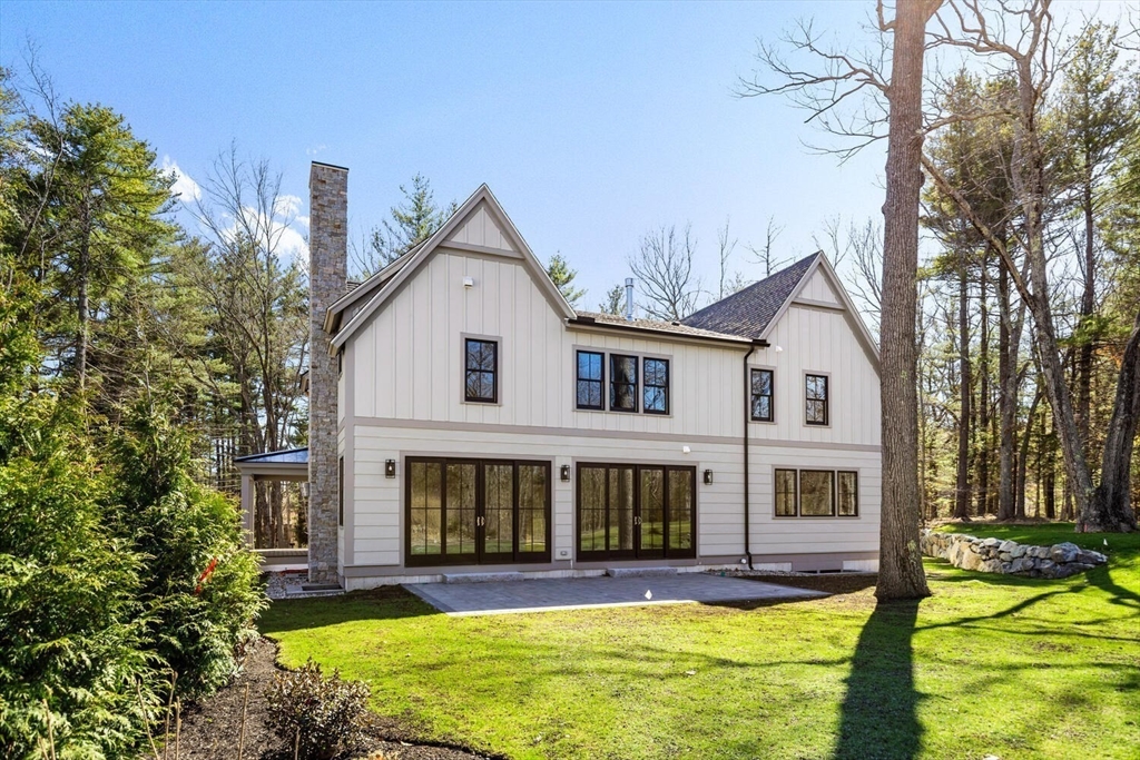 969 South Street Needham, MA 02492 - Photo 30 of 32 a view of a white house with a yard patio and a small yard