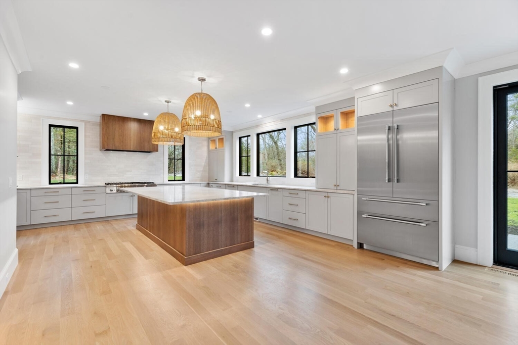 969 South Street Needham, MA 02492 - Photo 6 of 32 a large kitchen with stainless steel appliances granite countertop a large counter top a sink and a refrigerator