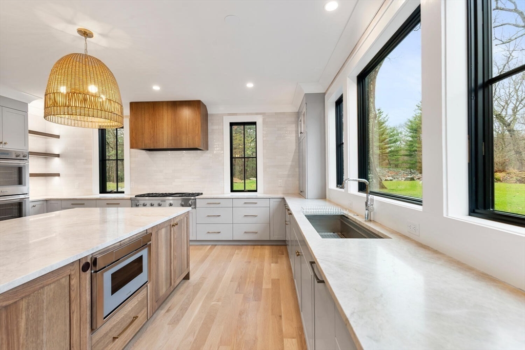 969 South Street Needham, MA 02492 - Photo 8 of 32 a large kitchen with a large window and a sink
