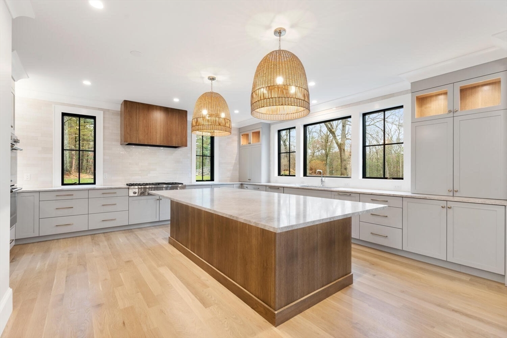 969 South Street Needham, MA 02492 - Photo 9 of 32 a large kitchen with stainless steel appliances a large counter top a stove and a sink