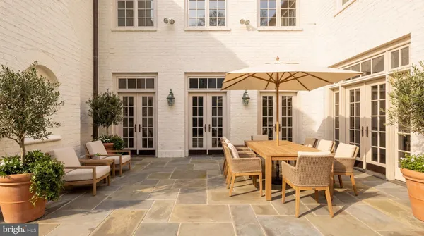 a view of a patio with table and chairs and potted plants