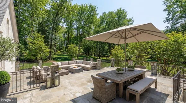 a view of a patio with table and chairs under an umbrella