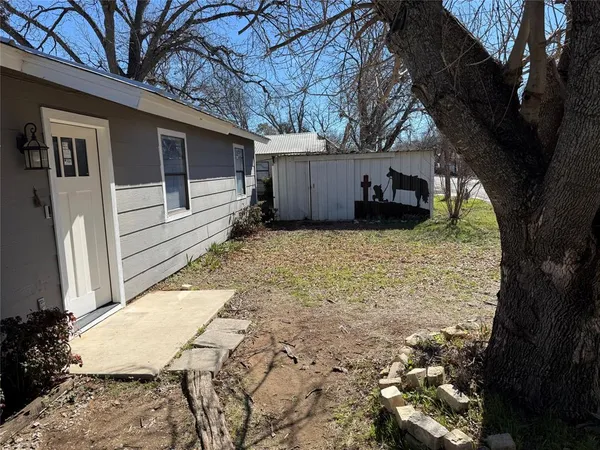 a view of a backyard with large trees