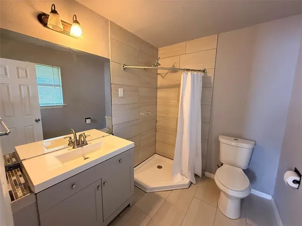 a bathroom with a toilet sink and shower