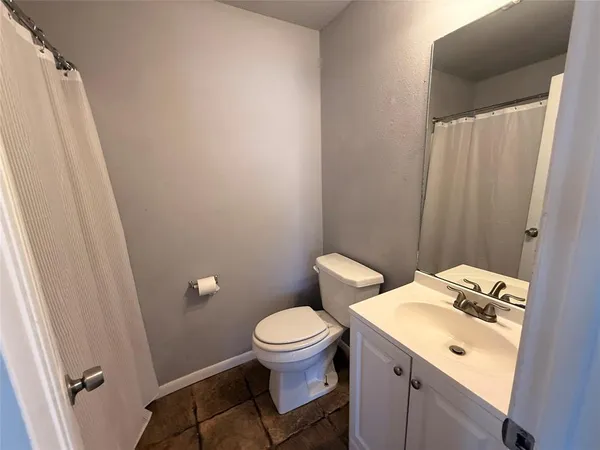 a bathroom with a sink toilet and a mirror
