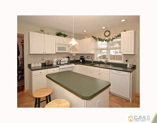 5 Crescent Road Old Bridge, NJ 08857 - Photo 2 of 8 a kitchen with a sink cabinets and wooden floor