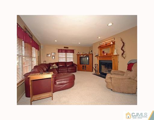 5 Crescent Road Old Bridge, NJ 08857 - Photo 5 of 8 a living room with furniture a fireplace and a large window