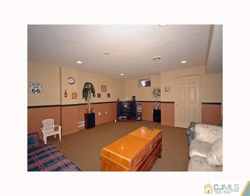 5 Crescent Road Old Bridge, NJ 08857 - Photo 6 of 8 a living room with furniture and a flat screen tv