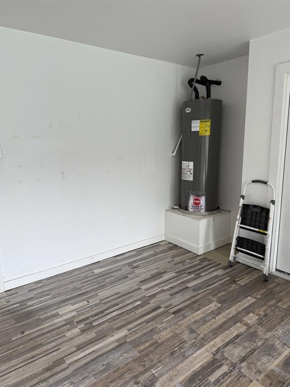 505 Thomas Street Terrell, TX 75160 - Photo 37 of 38 Wood-finish flooring with varied plank patterns, white baseboards, and a neutral wall color