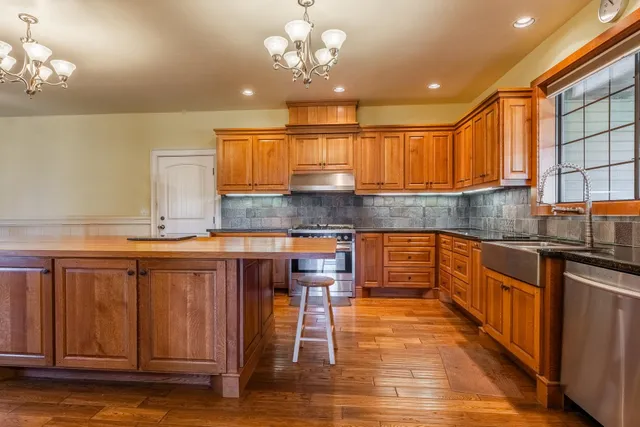 a kitchen with granite countertop wooden cabinets and a granite counter top