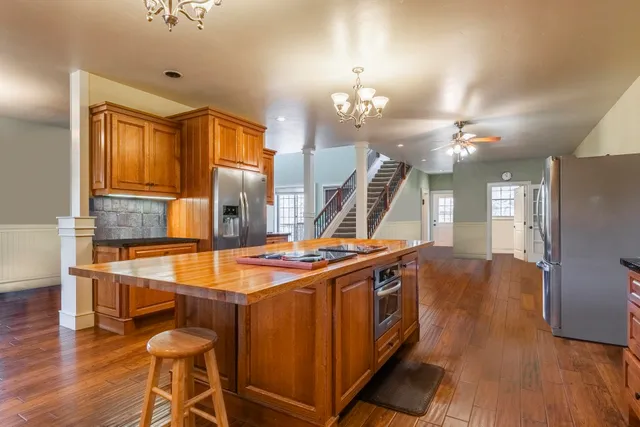 a view of a room with wooden floor and staircase