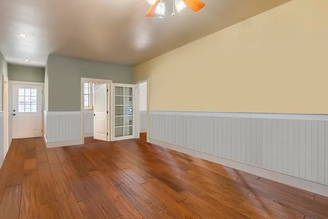 wooden floor in an empty room with a window