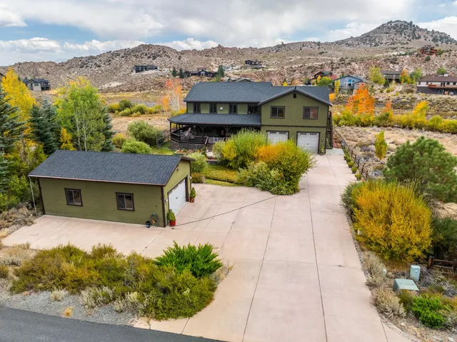 an aerial view of a house with a yard and lake view
