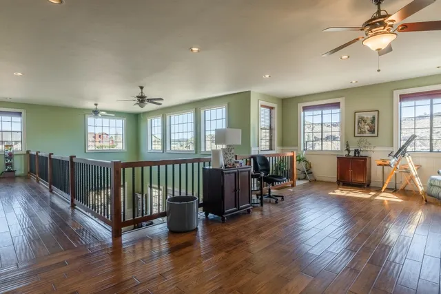 a living room with furniture window and wooden floor