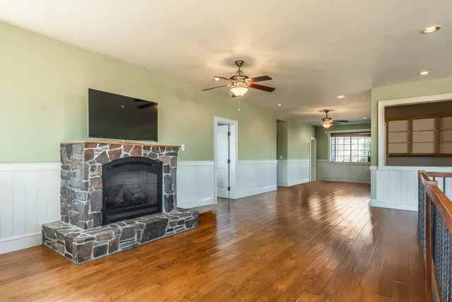 a view of an empty room with a fireplace and a window