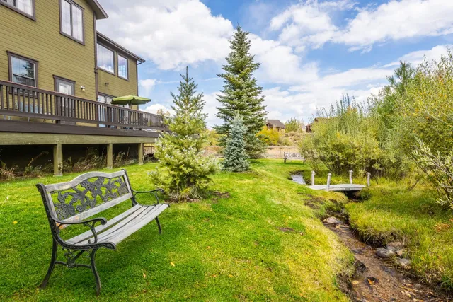 a backyard of a house with table and chairs