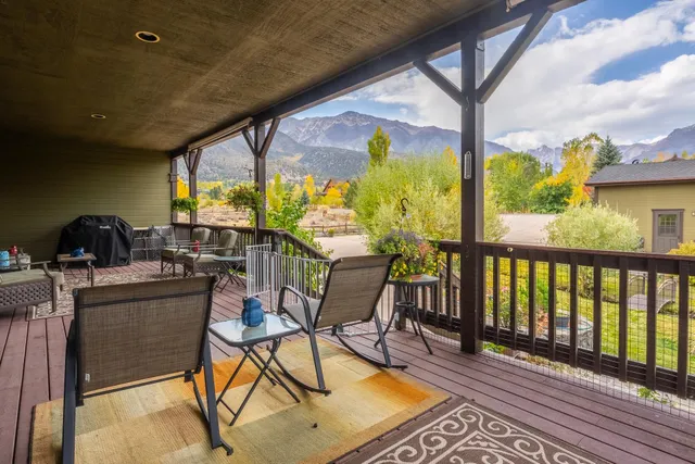 a view of a chairs and table in the balcony