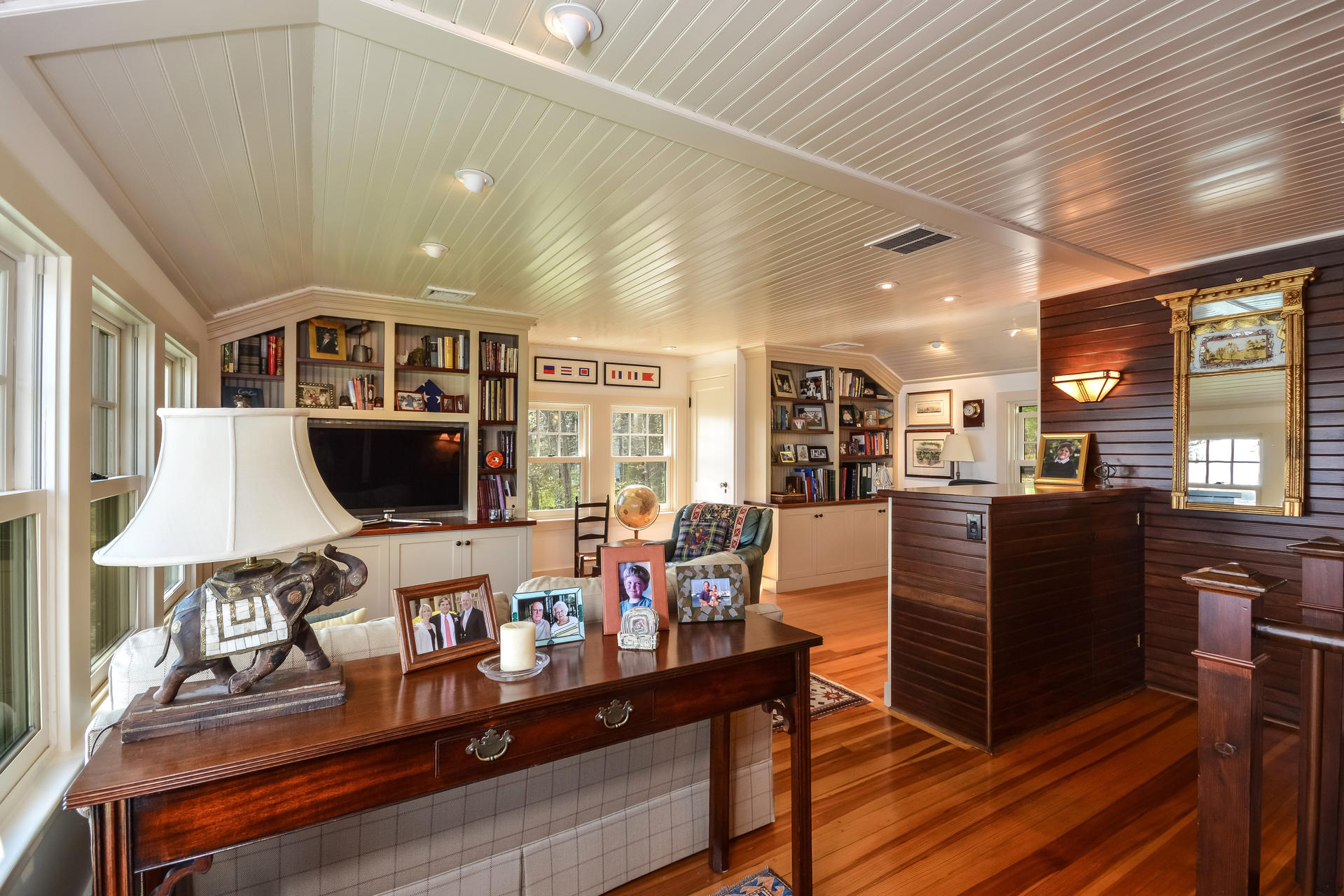 438 Scraggy Neck Road Cataumet, MA 02534 - Photo 18 of 33 a living room with furniture a flat screen tv and kitchen view