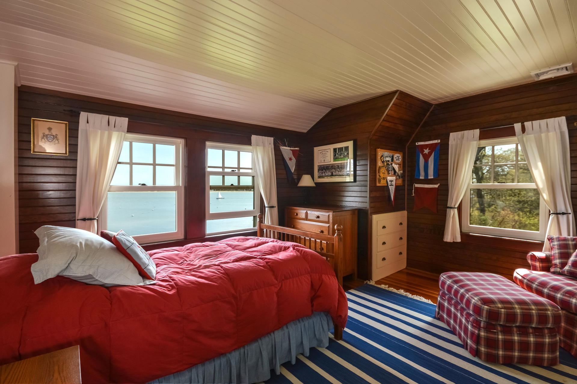 438 Scraggy Neck Road Cataumet, MA 02534 - Photo 21 of 33 a bedroom with a bed and wooden floor