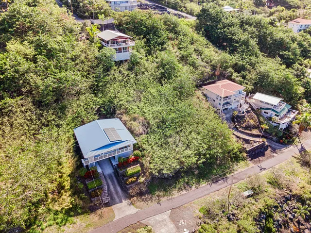 an aerial view of a house with a yard