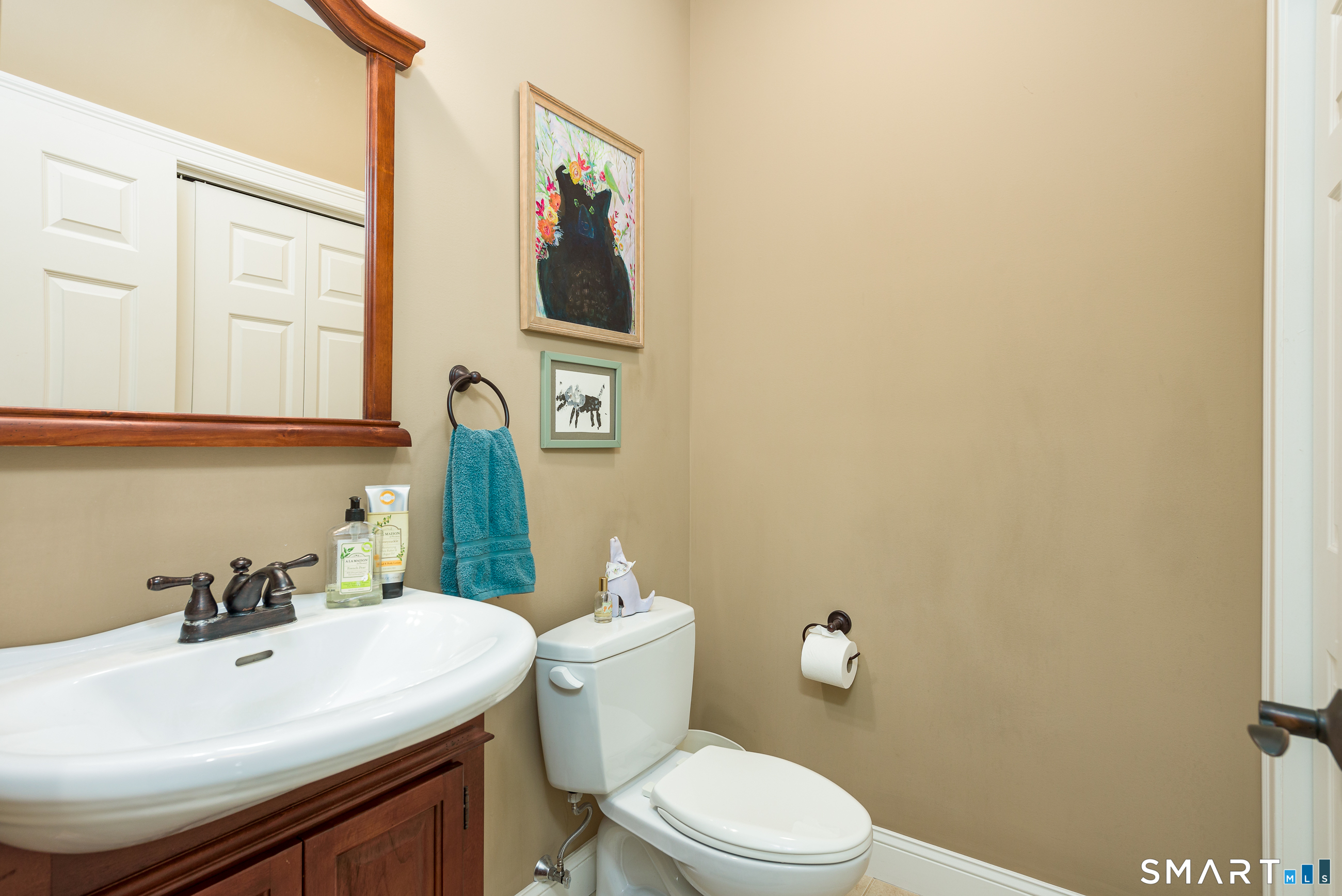 8 Greendale Drive, Unit 8 Suffield, CT 06078 - Photo 25 of 40 a bathroom with a sink a toilet and mirror