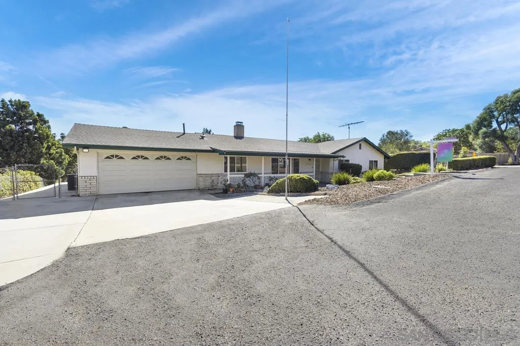 1007 Pepper Tree Lane Fallbrook, CA 92028 - Photo 1 of 34 a front view of a house with a yard and car parked