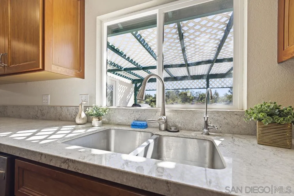 1007 Pepper Tree Lane Fallbrook, CA 92028 - Photo 13 of 34 a kitchen with a sink and a window