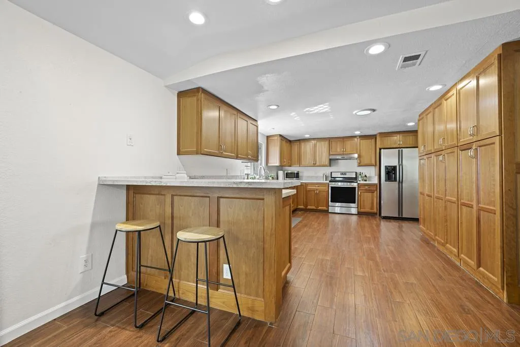 1007 Pepper Tree Lane Fallbrook, CA 92028 - Photo 14 of 34 a living room with stainless steel appliances kitchen island granite countertop furniture and a kitchen view