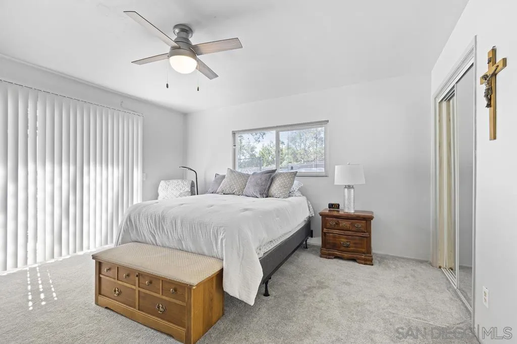 1007 Pepper Tree Lane Fallbrook, CA 92028 - Photo 15 of 34 a spacious bedroom with a bed and a chandelier
