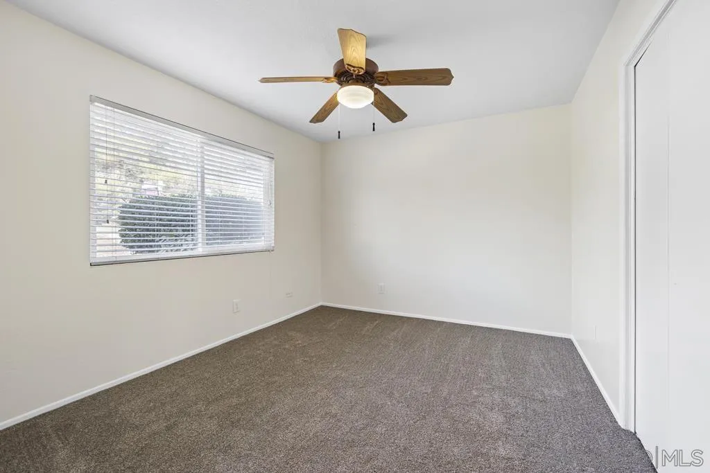 1007 Pepper Tree Lane Fallbrook, CA 92028 - Photo 20 of 34 an empty room with a window and a fan