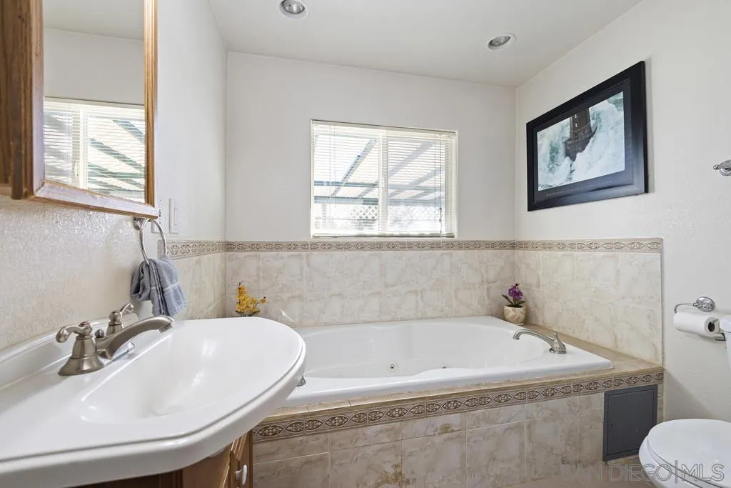 1007 Pepper Tree Lane Fallbrook, CA 92028 - Photo 22 of 34 a bathroom with a sink and a bathtub