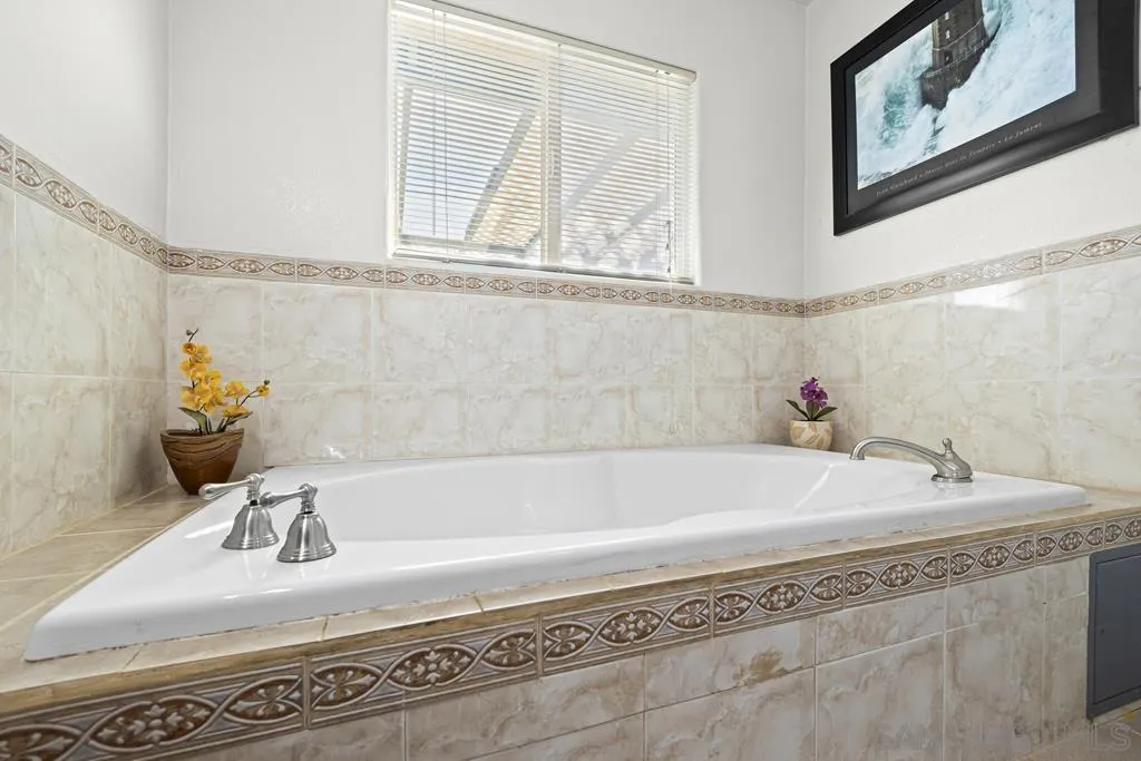 1007 Pepper Tree Lane Fallbrook, CA 92028 - Photo 24 of 34 a bathroom with a tub and a sink