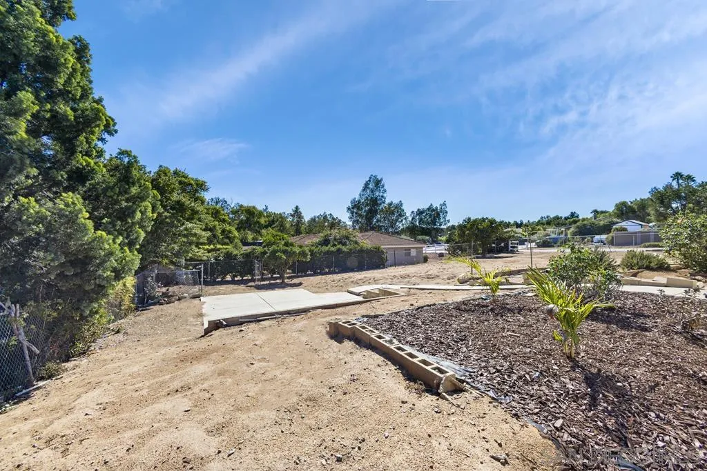 1007 Pepper Tree Lane Fallbrook, CA 92028 - Photo 28 of 34 a view of a dry yard with wooden fence