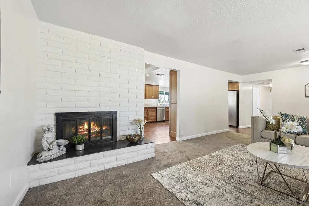 1007 Pepper Tree Lane Fallbrook, CA 92028 - Photo 3 of 34 a living room with furniture and a fireplace