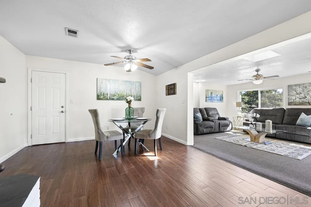 1007 Pepper Tree Lane Fallbrook, CA 92028 - Photo 9 of 34 a view of a dining room with furniture and wooden floor
