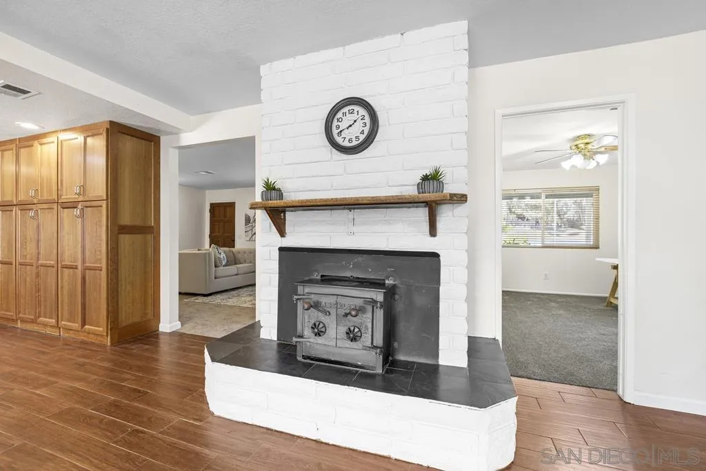 1007 Pepper Tree Lane Fallbrook, CA 92028 - Photo 10 of 34 a living room with a fireplace and a table
