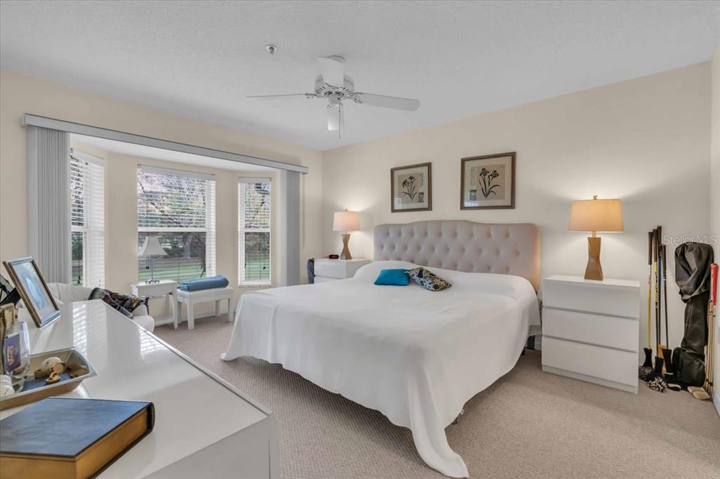 6713 Stone River Road, Unit 206 Bradenton, FL 34203 - Photo 25 of 58 a bedroom with a bed and large windows