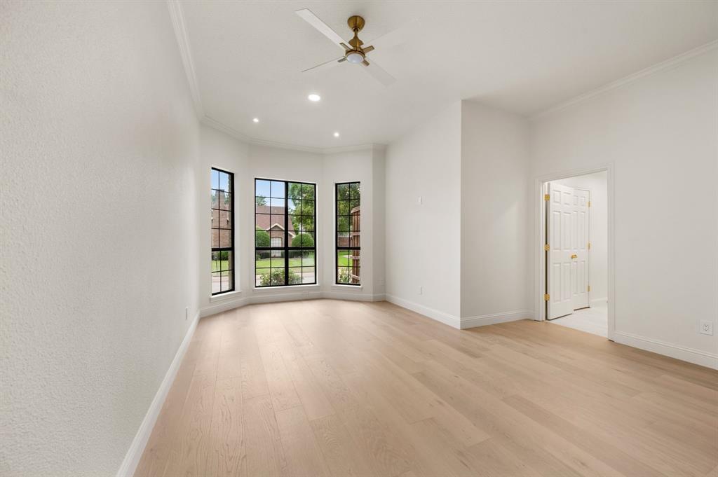 6403 Genstar Lane Dallas, TX 75252 - Photo 15 of 34 Spacious room featuring a bay window with black grid panes, recessed lighting, and crown molding