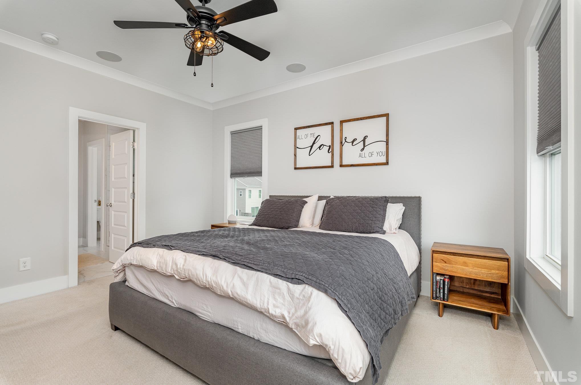 626 Watauga Street Raleigh, NC 27604 - Photo 12 of 30 a bedroom with a bed and a chandelier