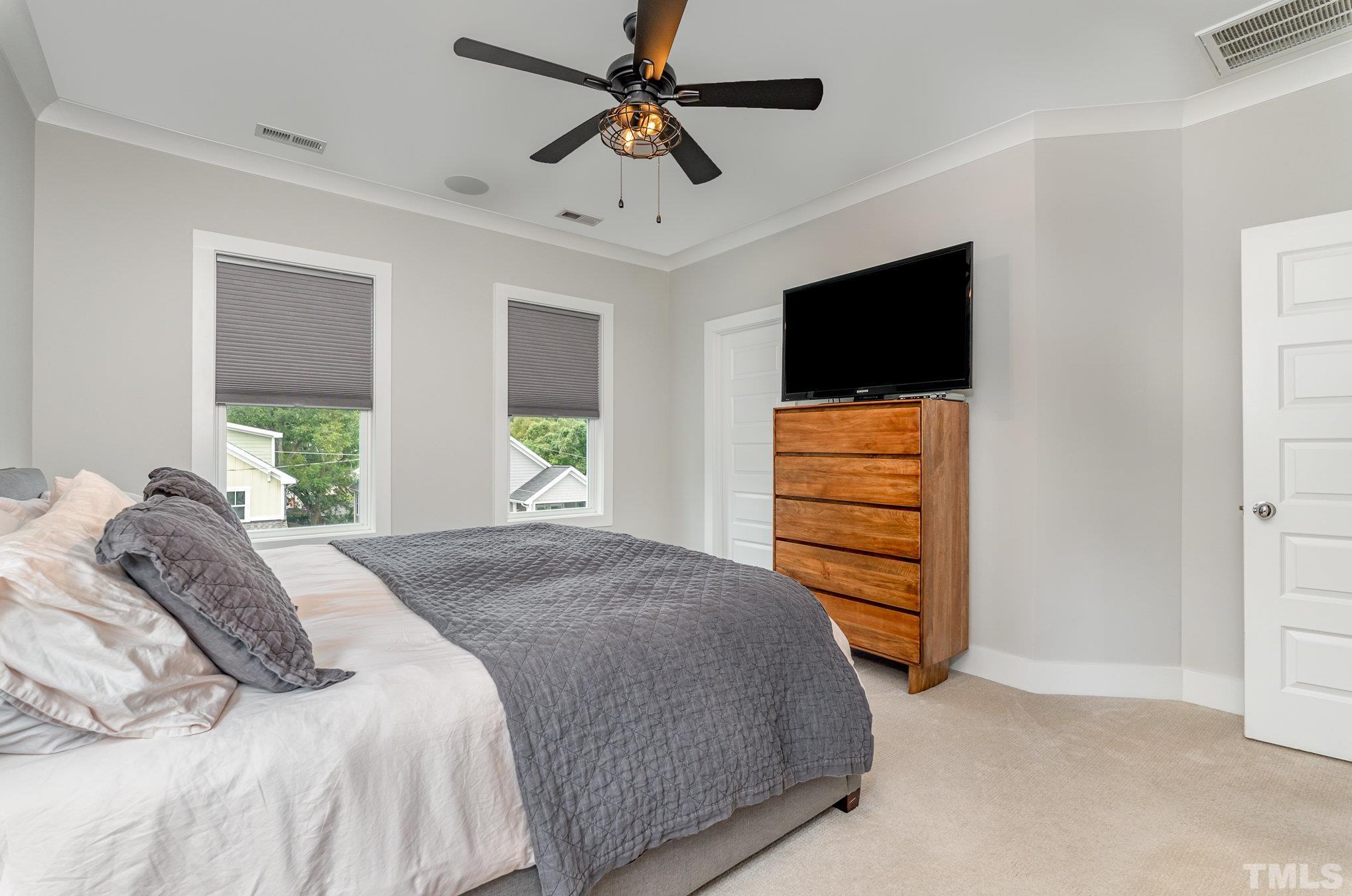 626 Watauga Street Raleigh, NC 27604 - Photo 13 of 30 a bedroom with a bed and a flat screen tv