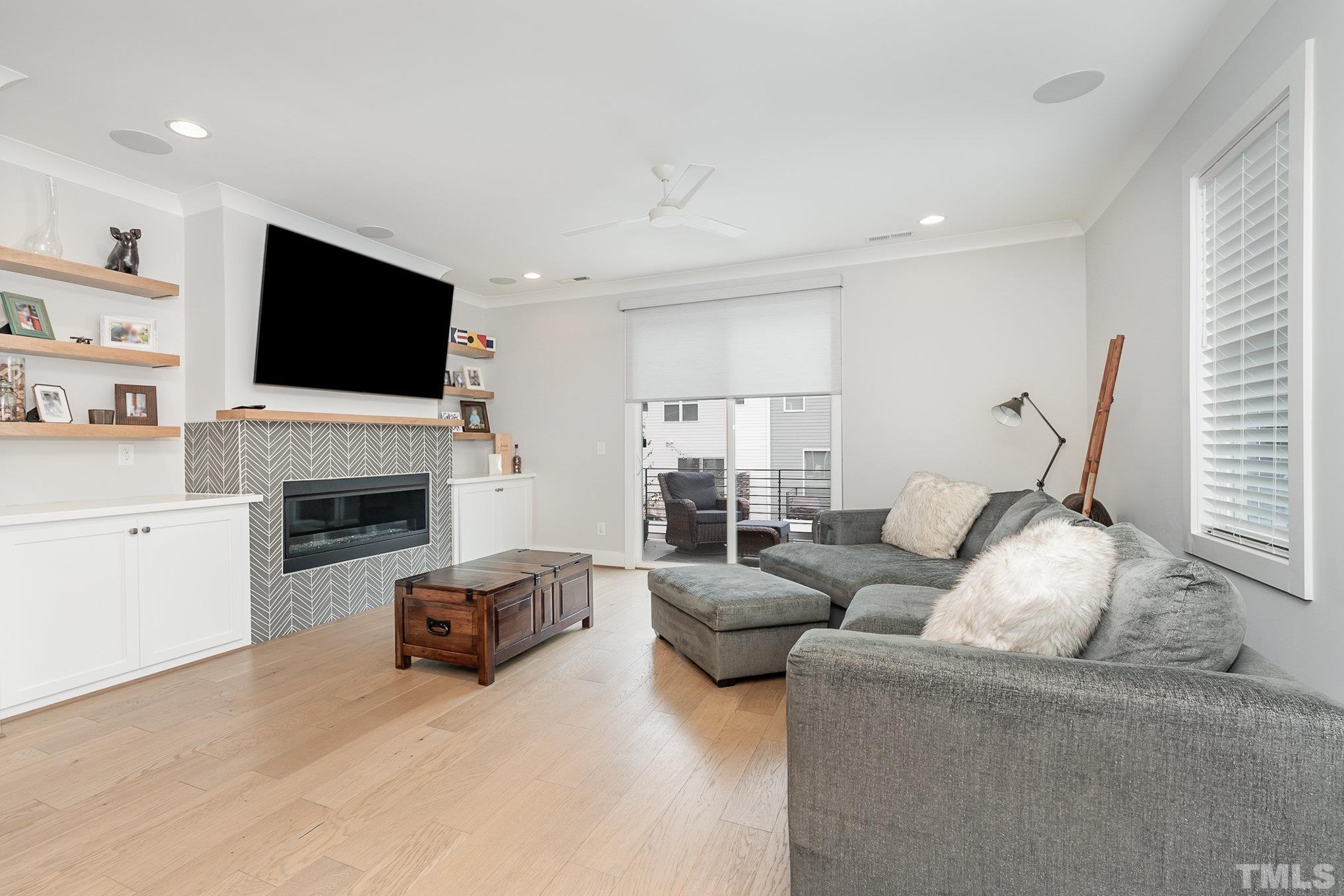 626 Watauga Street Raleigh, NC 27604 - Photo 9 of 30 a living room with furniture a fireplace and a flat screen tv