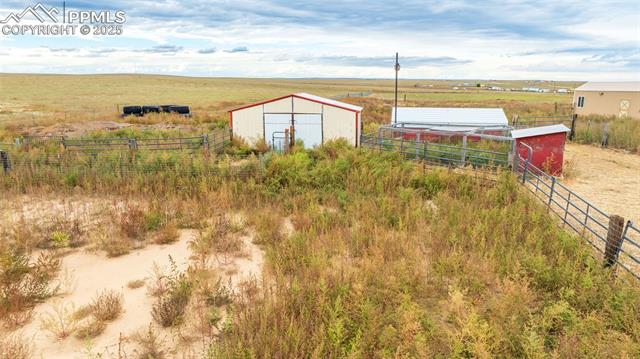 7940 Edison Road Yoder, CO 80864 - Photo 37 of 38 View of yard with a storage shed and a rural view