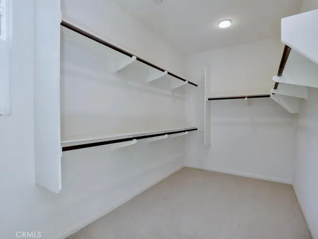 a view of a hallway with windows and closet