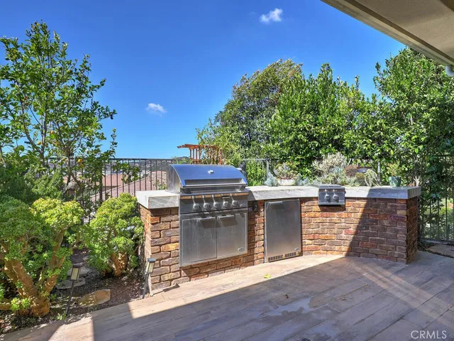 a porch with seating space and trees in the background