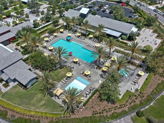 a patio with table and chairs and potted plants