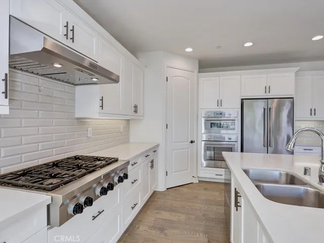 a kitchen with a sink and large window