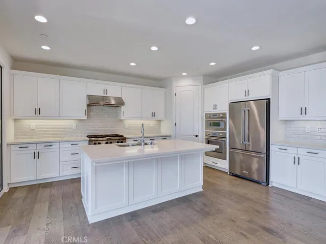 a view of empty room with wooden floor and windows